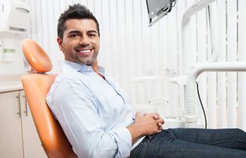 A man sitting in a dentist's chair.