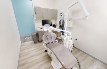 A treatment room with a dental machine and equipment at Buford Family Dental