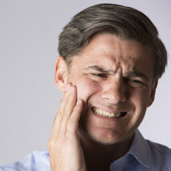 man suffering from toothache