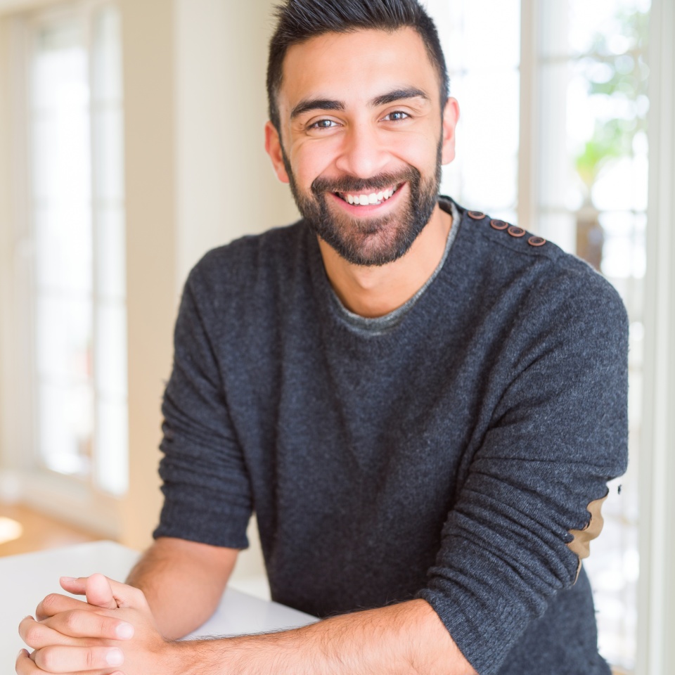 Handsome man smiling cheerful with a big smile on face showing teeth, positive and happy expression