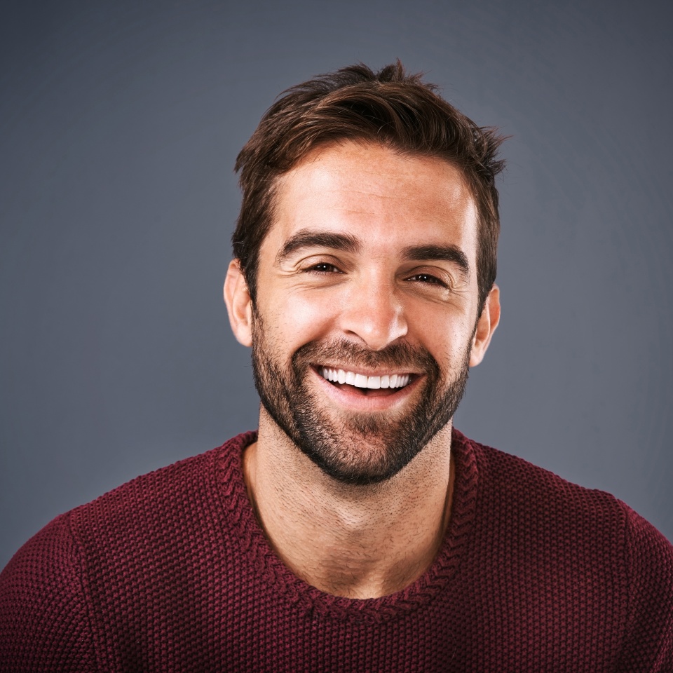 Confidence, face and smile of man in studio, sweater and warm for winter in Canada, happy and discount. Gray background, portrait and joy of person, sale and cardigan of cotton, clothes and jersey
