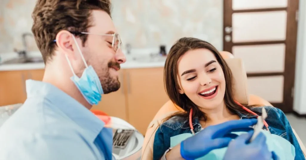 Dentist showing same-day dental result to smiling patient in chair