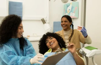 Happy patient learning about dental implants in Buford clinic
