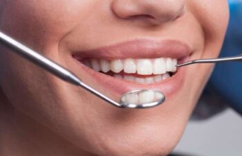 Patient receiving a dental examination at Buford Family Dental during a cosmetic and family dentistry appointment to maintain a healthy, confident smile.