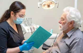 Senior patient discussing dental care with dentist in Buford